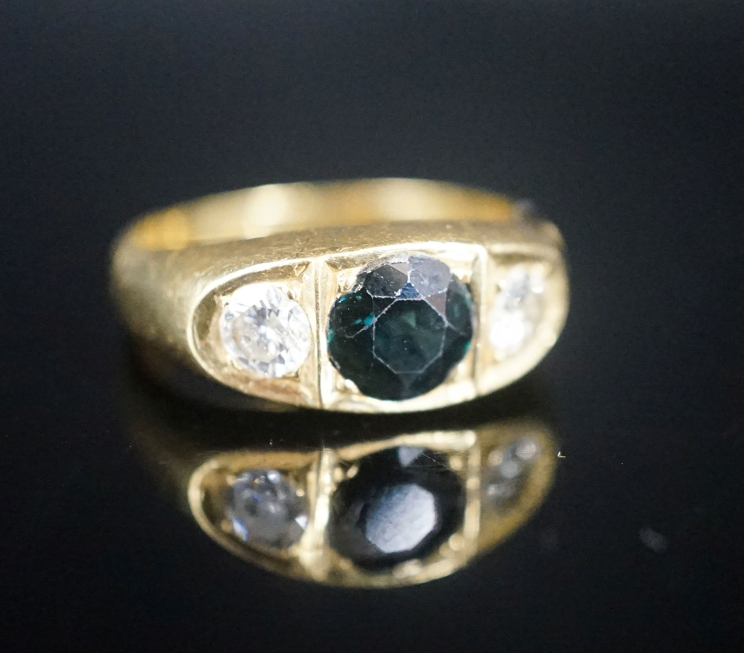 An 18ct gypsy set sapphire and diamond three stone ring, size U, gross 11.8 grams